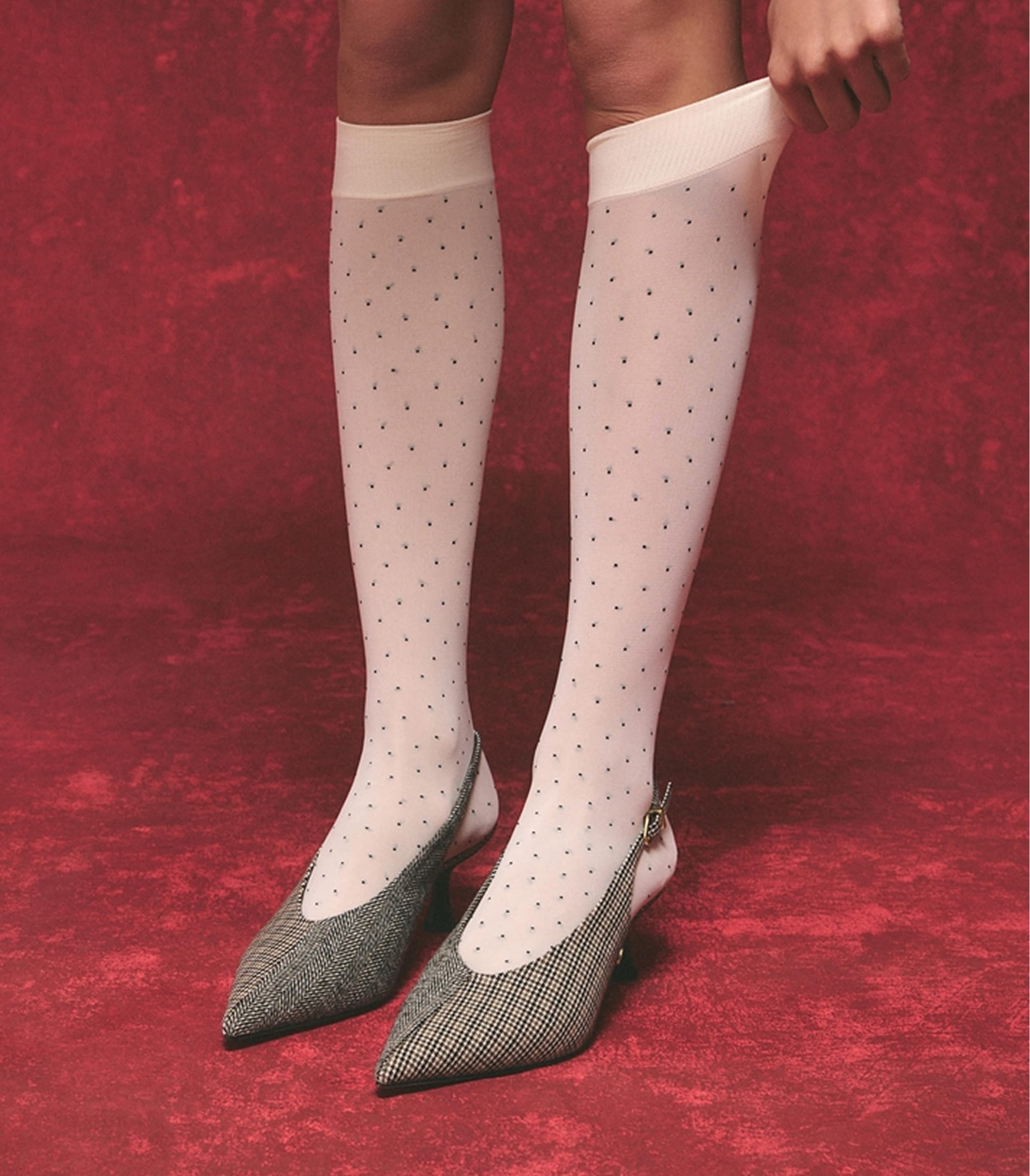 woman wearing the fawn slingback pump with white polka dot socks