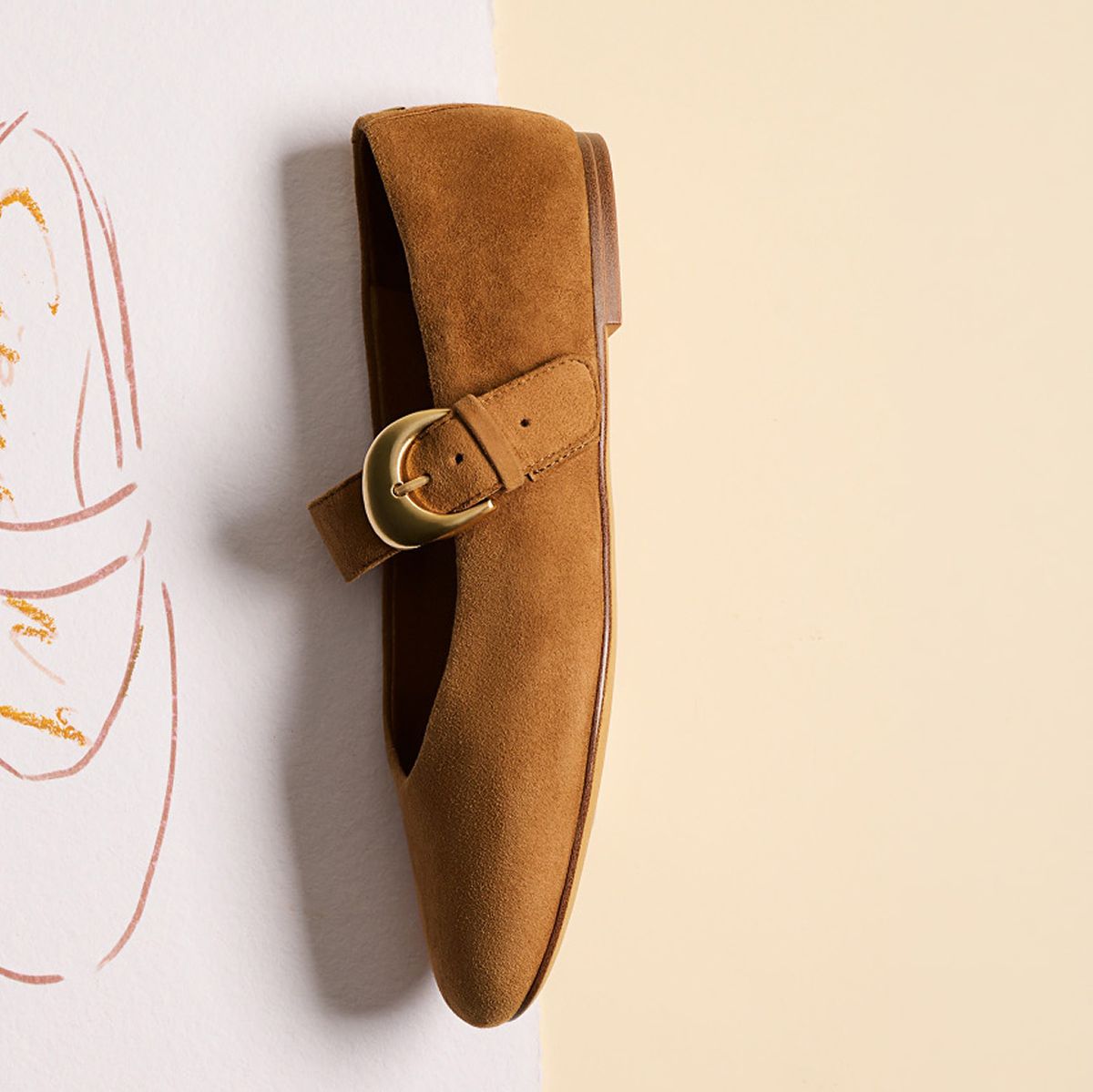 The Bella Mary Jane Flat in brown suede with a gold buckle, displayed beside a partial design sketch.